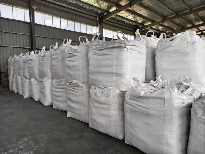 Rows of 1,000 kg bulk totes of seabird guano stored in the warehouse, loaded without pallets